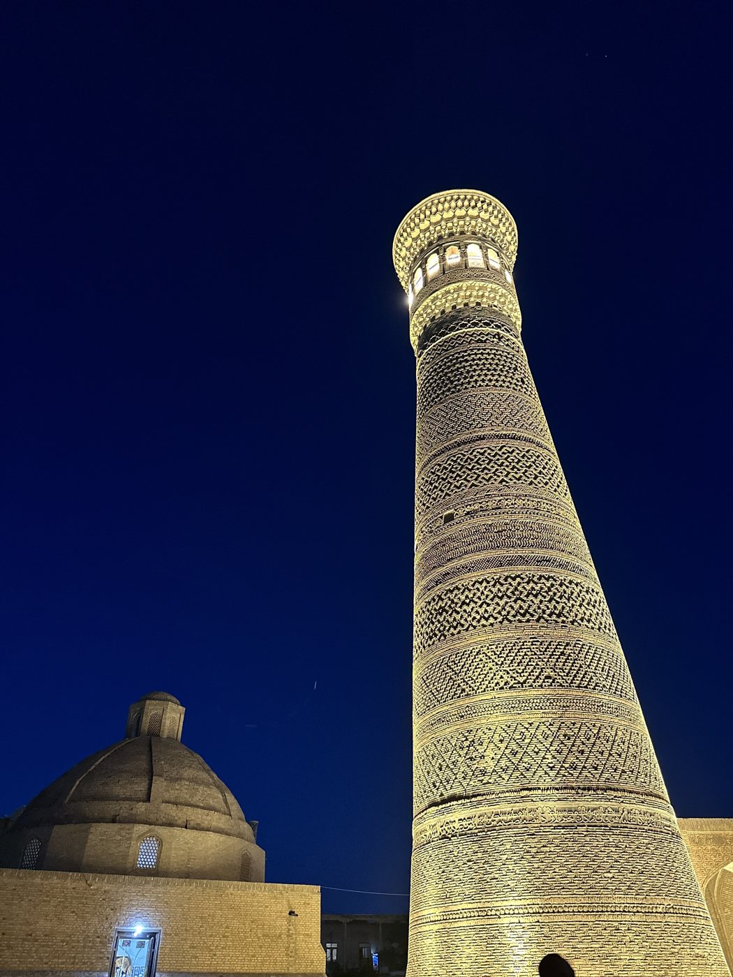 The illuminated Kalyan Minaret against the night sky in Bukhara