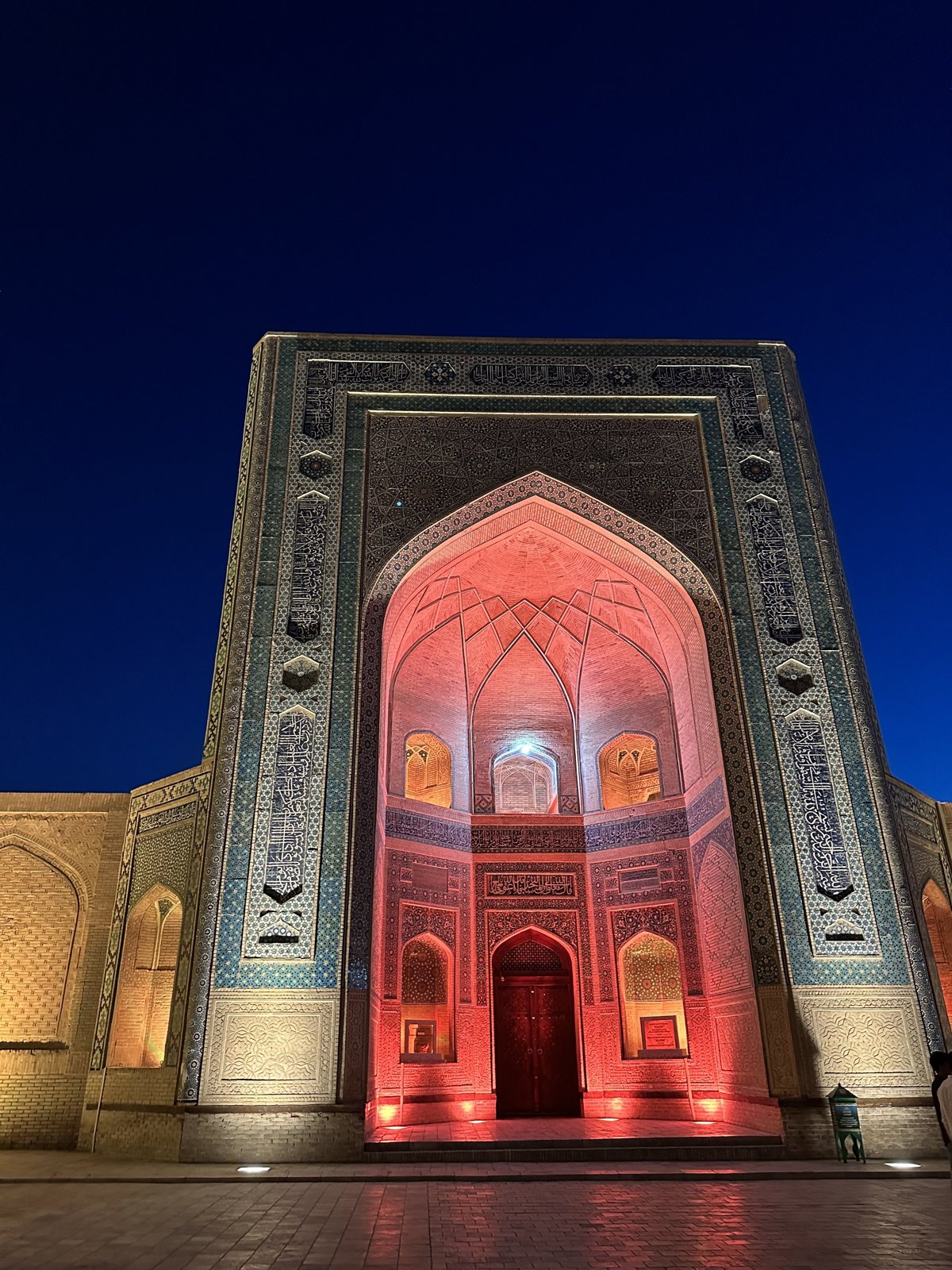 Illuminated tiled entrance in Bukhara at night