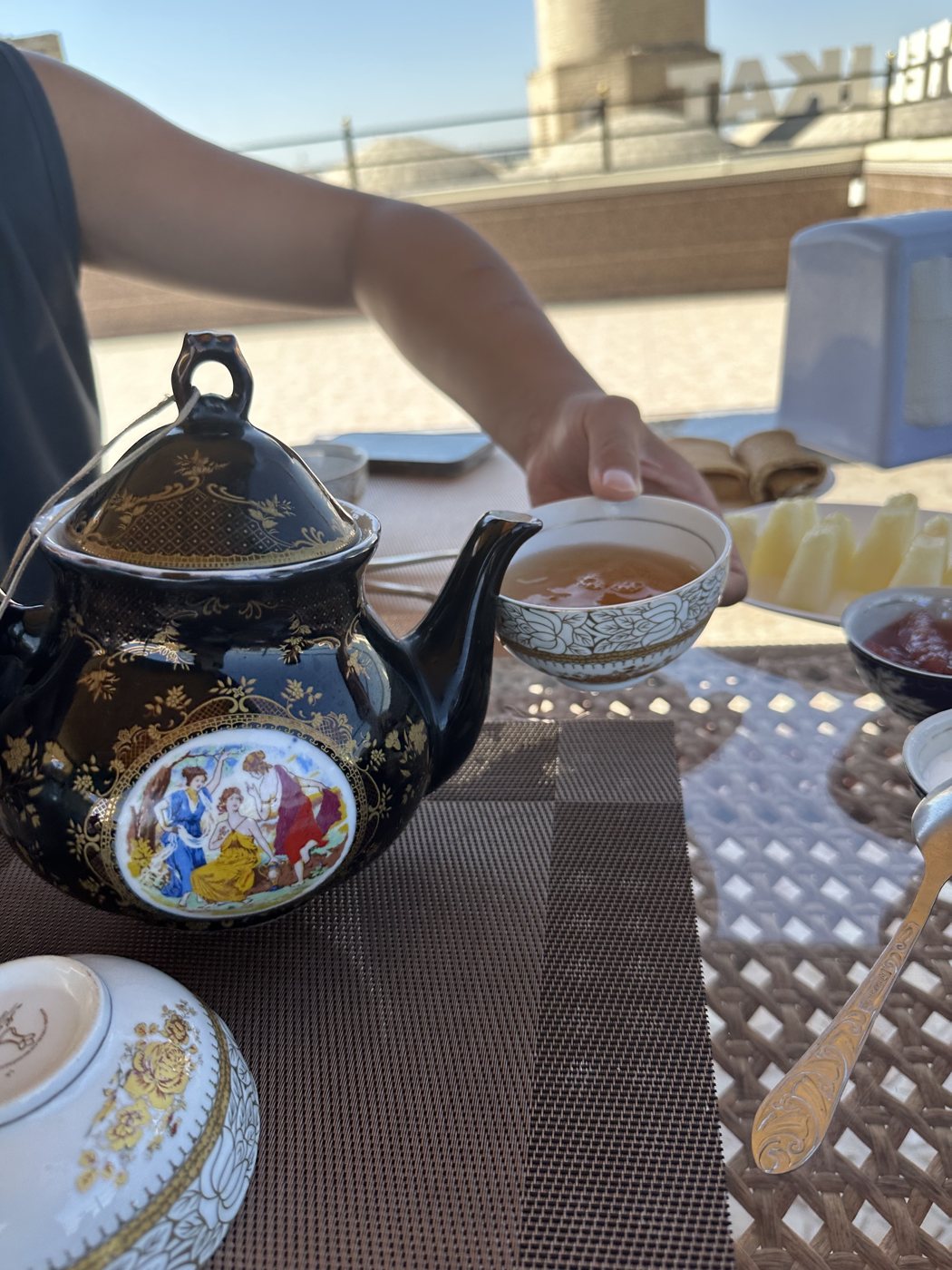 Decorated teapot and cups with bread in Bukhara